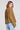 Back view of a woman wearing the Saltwater Luxe Havenn Fawn Sweater on a neutral background