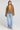 A full body front view of a woman wearing the Saltwater Luxe Havenn Fawn Sweater on a neutral background
