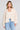 Front view of a woman wearing the Saltwater Luxe Havenn Natural Sweater on a neutral background