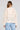 Back view of a woman wearing the Saltwater Luxe Havenn Natural Sweater on a neutral background
