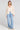 A full body front view of a woman wearing the Saltwater Luxe Havenn Natural Sweater on a neutral background