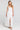 Front view of a woman wearing the Saltwater Luxe Hayley Midi Dress on a neutral background
