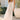 Front view of a woman wearing the Saltwater Luxe Hayley Midi Dress in a garden