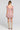 Back view of a woman wearing the Saltwater Luxe Holand Mini Dress on a neutral background