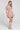 Side angle view of a woman wearing the Saltwater Luxe Holand Mini Dress on a neutral background