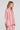 Side angle front view of a woman wearing the Saltwater Luxe Isadore Top in Coffee on a neutral background