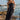 Front view of a woman wearing the Saltwater Luxe Jackstin Black Midi Dress on the beach