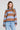 Front view of a woman wearing the Saltwater Luxe Kirra Dusty Blue Sweater on a neutral background
