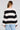 Back view of a woman wearing the Saltwater Luxe  Kirra Natural Sweater  on a neutral background