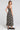 Back view of a woman wearing the Saltwater Luxe Kymber Midi Dress in Black on a neutral background