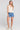 A full body front view of a woman wearing the Saltwater Luxe Lissa Sweater Vest in White on a neutral background