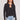 Front view of a woman wearing the Saltwater Luxe Long Sleeve Black Cardigan on a neutral background