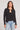 Front view of a woman wearing the Saltwater Luxe Long Sleeve Black Cardigan on a neutral background