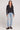 A full body front view of a woman wearing the Saltwater Luxe Long Sleeve Black Cardigan on a neutral background