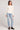 Full body front view of a woman wearing the Saltwater Luxe Long Sleeve Ecru Cardigan on a neutral background