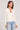 Front view of a woman wearing the Saltwater Luxe Long Sleeve Ecru Cardigan on a neutral background
