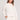Front view of a woman wearing the Saltwater Luxe Long Sleeve Ecru Pullover on a neutral background