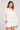Front view of a woman wearing the Saltwater Luxe Long Sleeve Ecru Pullover on a neutral background