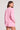 Back view of a woman wearing the Saltwater Luxe Long Sleeve Petunia Pullover on a neutral background