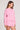 Side angle view of a woman wearing the Saltwater Luxe Long Sleeve Petunia Pullover on a neutral background
