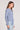Side angle view of a woman wearing the Saltwater Luxe  Long Sleeve Worn Blue Cardigan on a neutral background