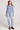 Full body front view of a woman wearing the Saltwater Luxe  Long Sleeve Worn Blue Cardigan on a neutral background