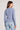 Back view of a woman wearing the Saltwater Luxe  Long Sleeve Worn Blue Cardigan on a neutral background