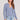 Front view of a woman wearing the Saltwater Luxe  Long Sleeve Worn Blue Cardigan on a neutral background