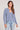 Front view of a woman wearing the Saltwater Luxe  Long Sleeve Worn Blue Cardigan on a neutral background