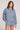 Front view of a woman wearing the Saltwater Luxe Long Sleeve Worn Blue Pullover on a neutral background