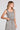 Side angle view of a woman wearing the Saltwater Luxe Louissa Tank on a neutral background