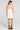 Back view of a woman wearing the Saltwater Luxe Lukas Mini Dress on a neutral background