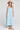 Front view of a woman wearing the Saltwater Luxe Marcelia Azure Blue Midi Dress on a neutral background
