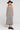 Front view of a woman wearing the Saltwater Luxe Marcelia Black Midi Dress on a neutral background