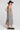 Back side angle view of a woman wearing the Saltwater Luxe Marcelia Black Midi Dress on a neutral background