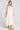 Side angle view of a woman wearing the Saltwater Luxe Marcelia Salt on a neutral background