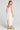 Back view of a woman wearing the Saltwater Luxe Marcelia Salt on a neutral background