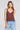 Front view of a woman wearing the Saltwater Luxe Marlie Coffee Tank on a neutral background