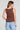 Back view of a woman wearing the Saltwater Luxe Marlie Coffee Tank on a neutral background