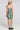 Back view of a woman wearing the Saltwater Luxe Marria Mini Dress on a neutral background