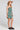 Side view of a woman wearing the Saltwater Luxe Marria Mini Dress on a neutral background