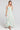 Front view of a woman wearing the Saltwater Luxe Medina Midi Dress in Pearl on a neutral background