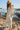 Front view of a woman wearing the Saltwater Luxe Medina Midi Dress in Pearl on the beach