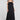 Front view of a woman wearing the Saltwater Luxe Melia Black Maxi Dress on a neutral background