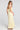 Back view of a woman wearing the Saltwater Luxe Melia Sunglow Maxi Dress on a neutral background