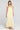 Front view of a woman wearing the Saltwater Luxe Melia Sunglow Maxi Dress on a neutral background