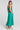 Back view of a woman wearing the Saltwater Luxe Memphis Midi Dress on a neutral background