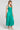 Side angle view of a woman wearing the Saltwater Luxe Memphis Midi Dress on a neutral background