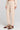 Side angle view of a woman wearing the Saltwater Luxe Millie Oatmeal Pant on a neutral background