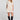 Front view of a woman wearing the Saltwater Luxe Nicko Natural Mini Dress on a neutral background